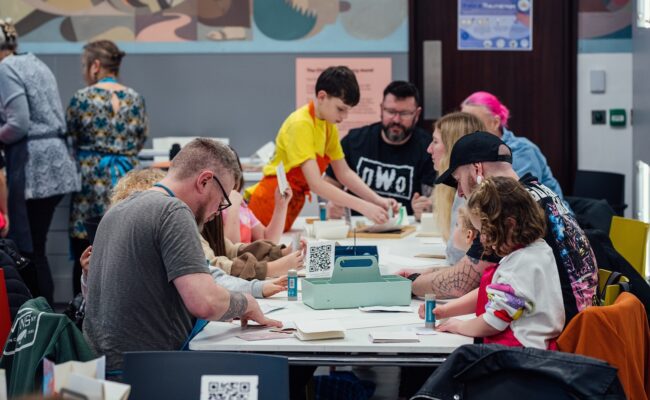 Photograph showing a workshop with families doing a craft activity