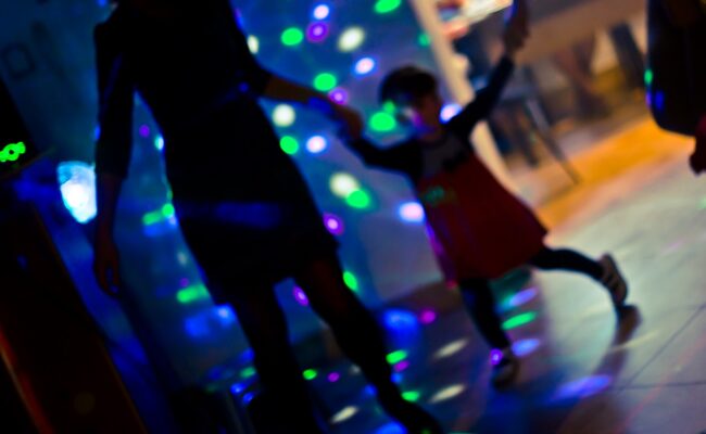 Colour photograph showing a family dancing at a disco