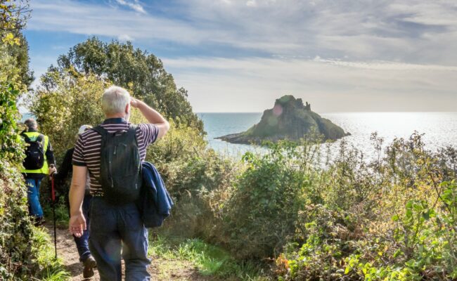 walkers along the South West Coast Path at Torquay, English Riviera, on a sunny day