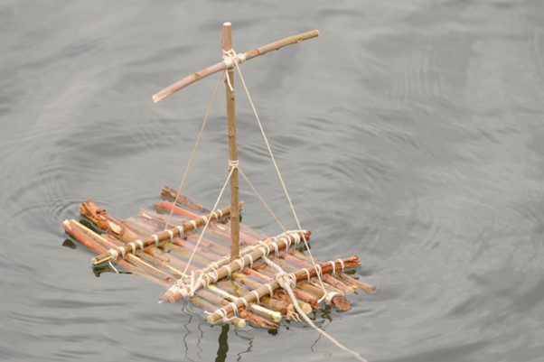 A model raft made from twigs and string floats in water