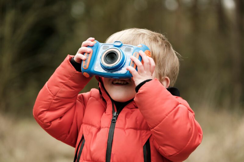 Child looking through a camera